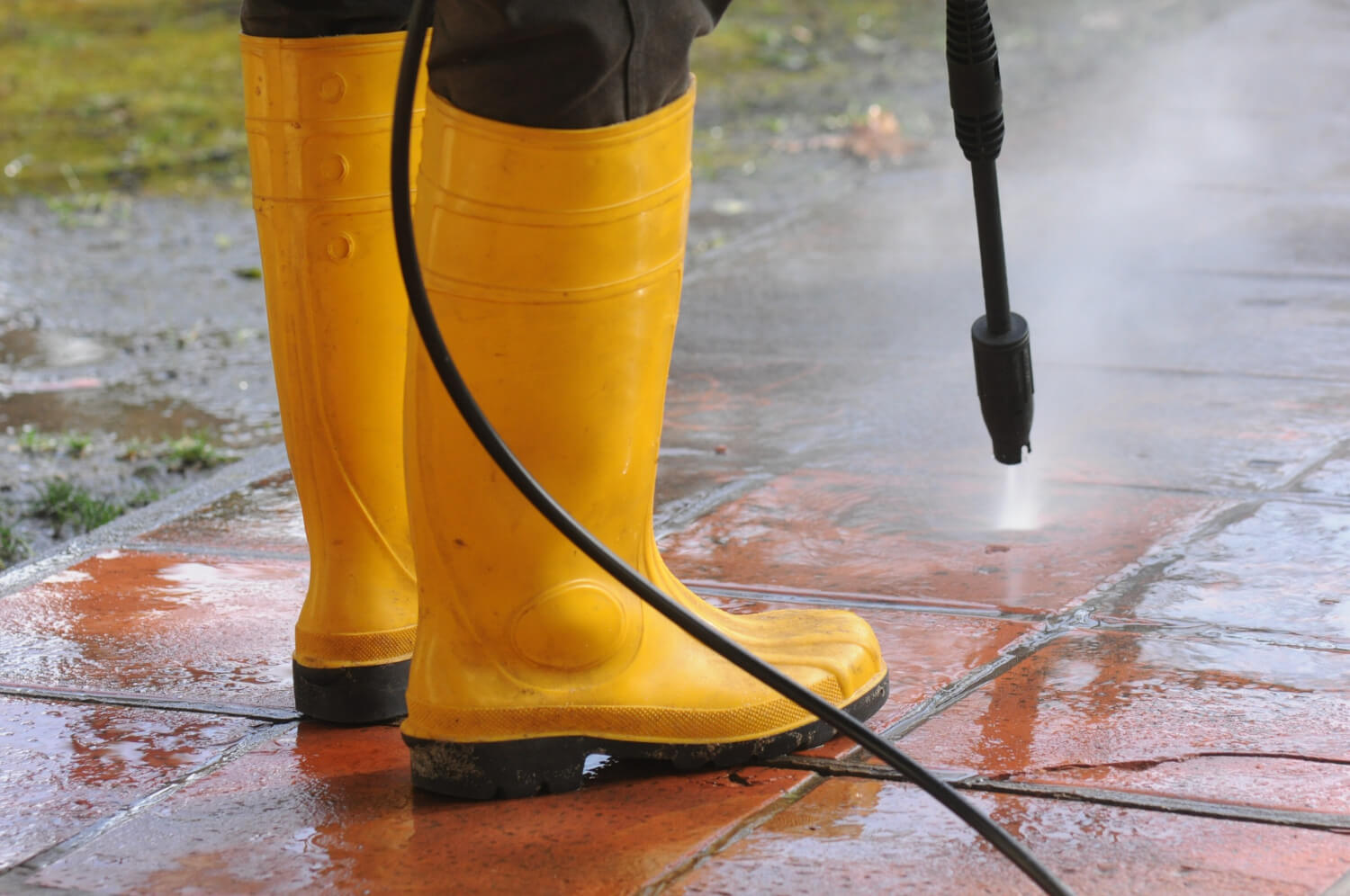 professional power washing a house exterior
